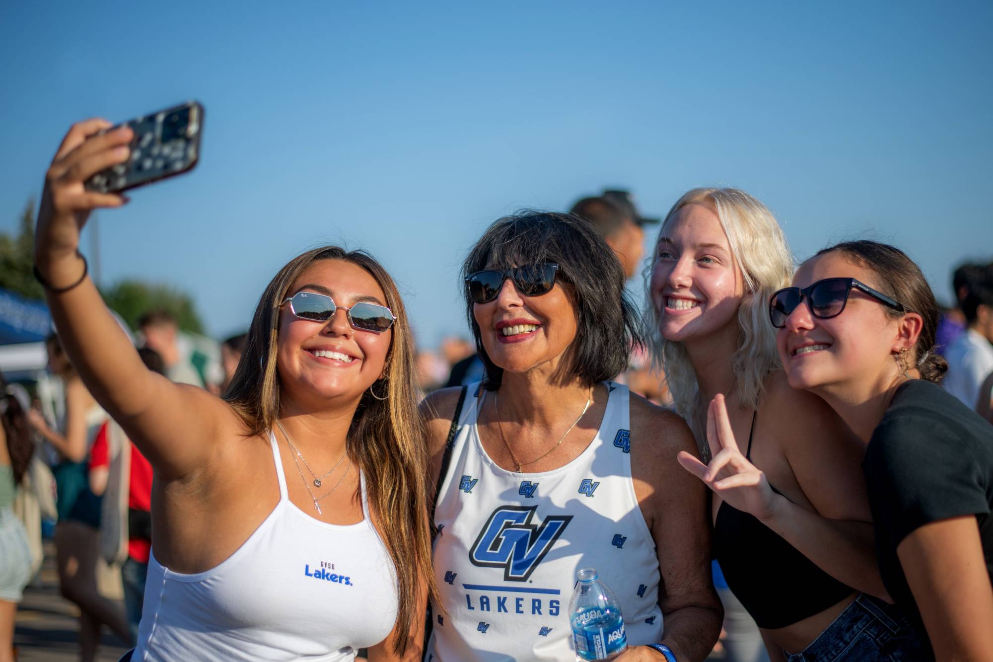 Students and the president of GVSU posing for a picture.